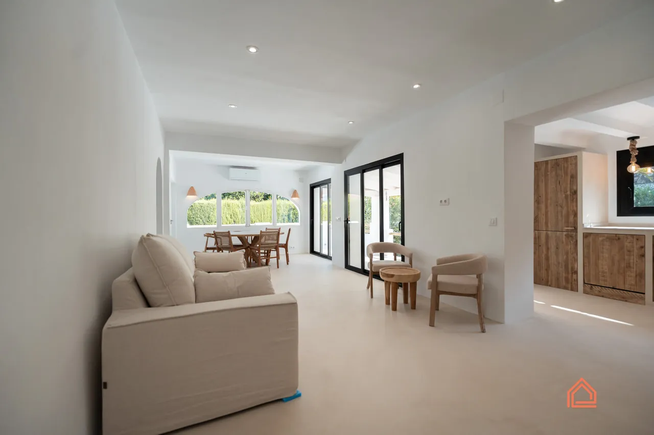 Long open-plan living room with sofa and dining area