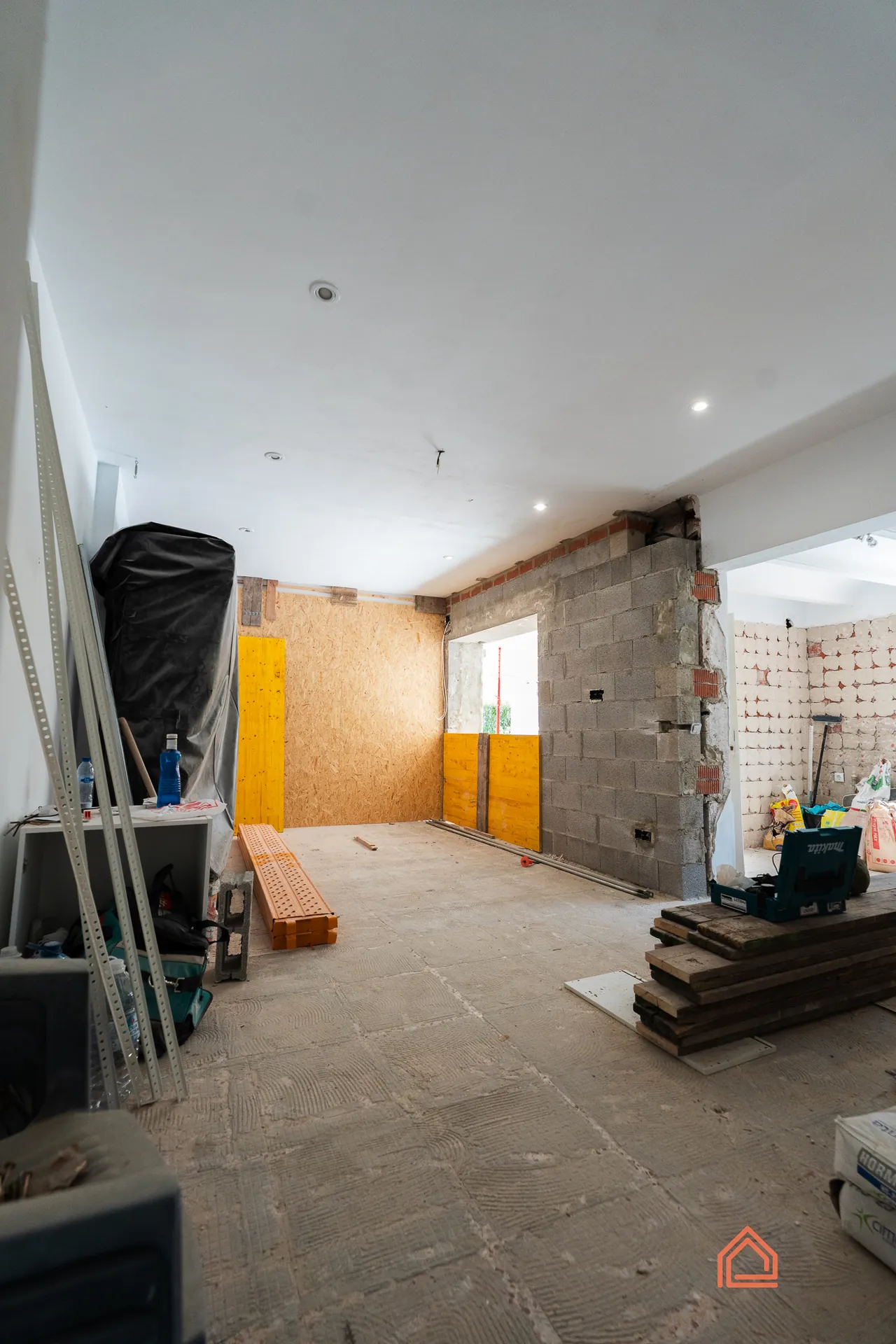 Interior during renovation with stripped walls and building materials