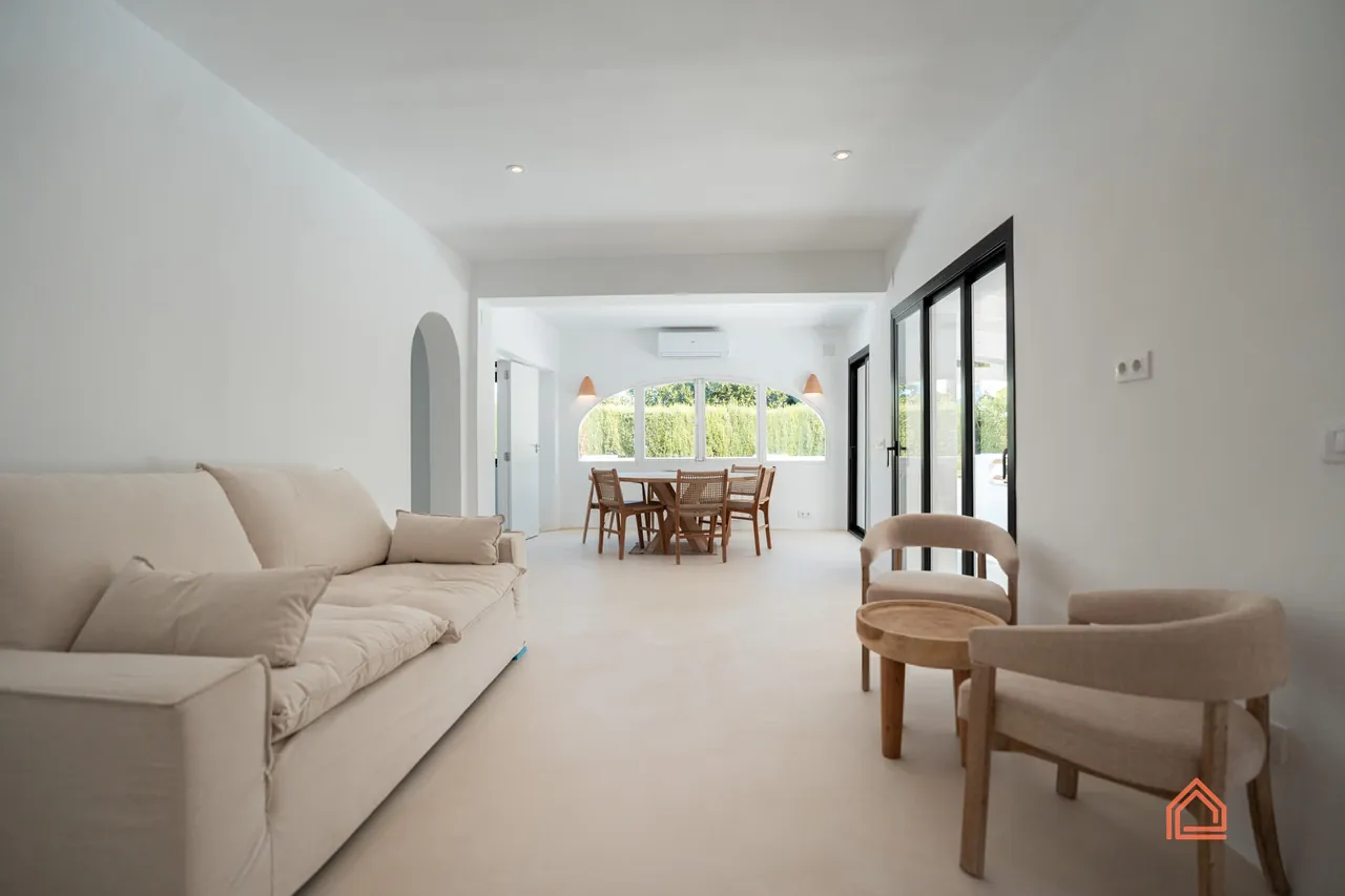 Lounge with cream sofa leading through to the dining area