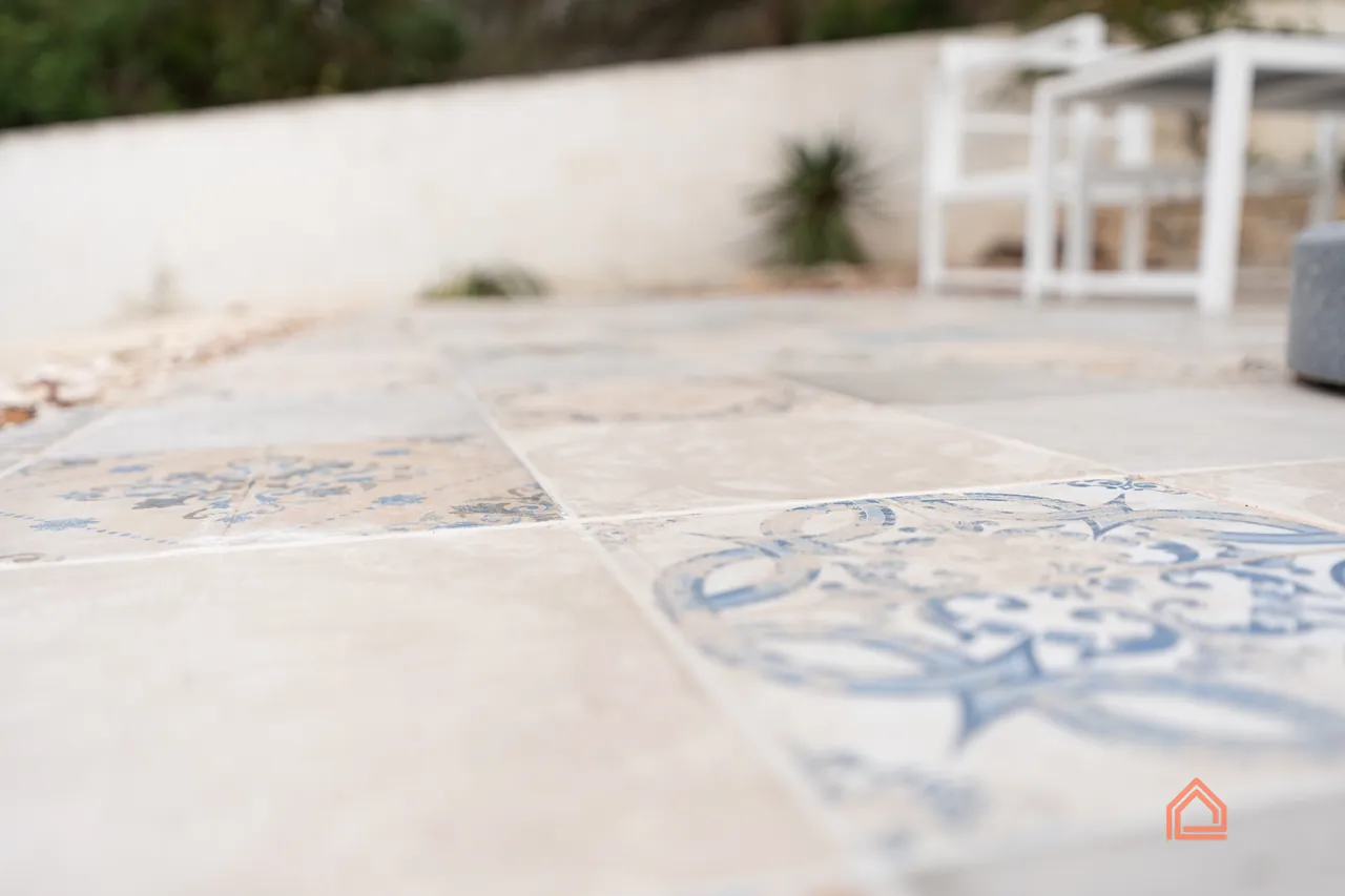 Close-up of blue and white patterned patio tiles